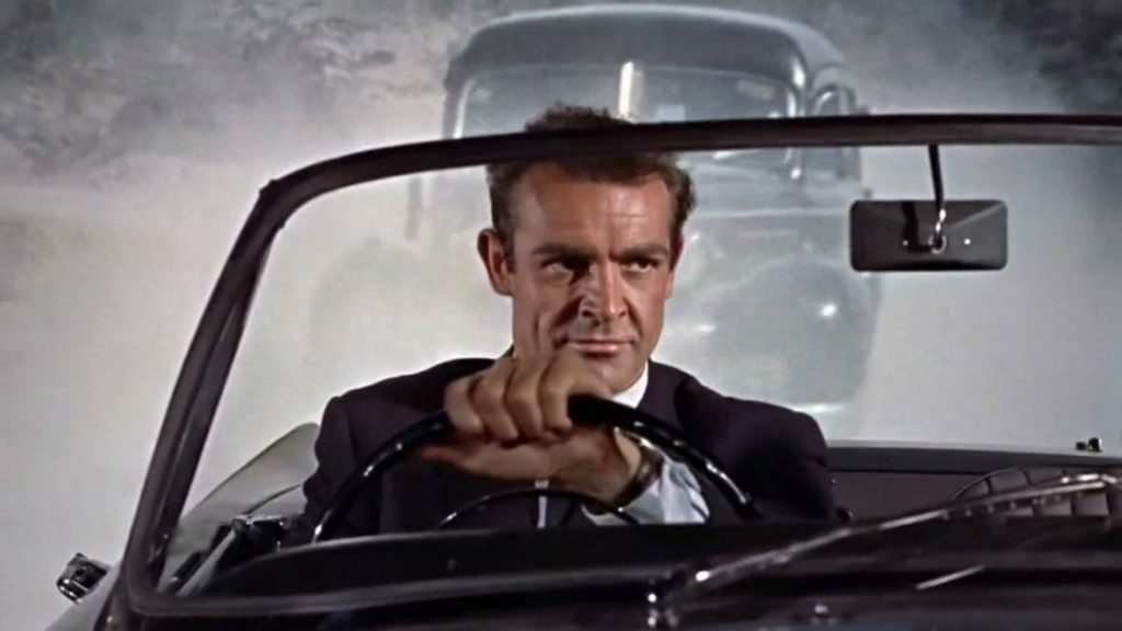 Sean Connery as James Bond appears to be driving a moving car, but thanks to rear screen projection, his car is static and a moving image is being projected onto the screen behind him to give the impression that he is driving.